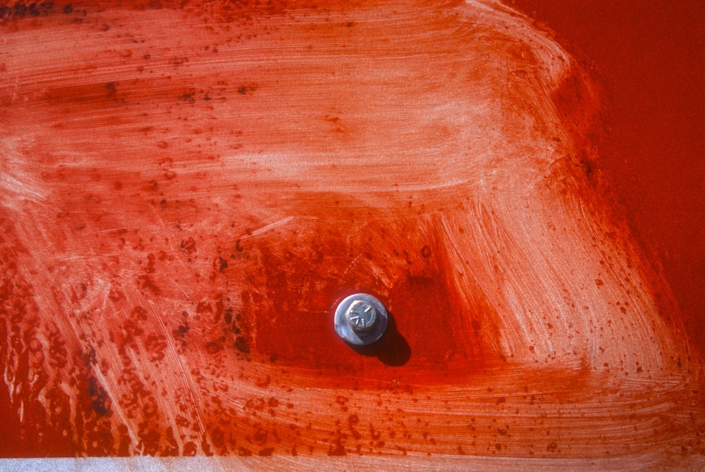 a can of soda sitting on top of a red table