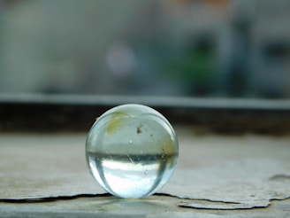 A close-up of the icelia ice globe resting on a smooth marble surface with soft natural light.