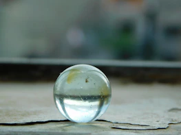 Close-up of polished marble and glass decorative items reflecting soft natural light.