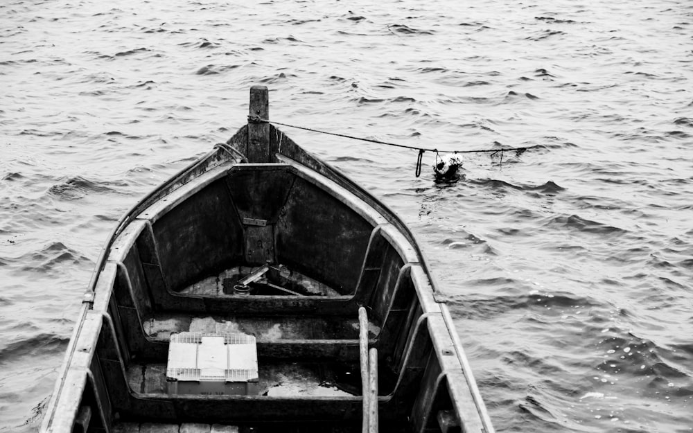 a black and white photo of a boat in the water