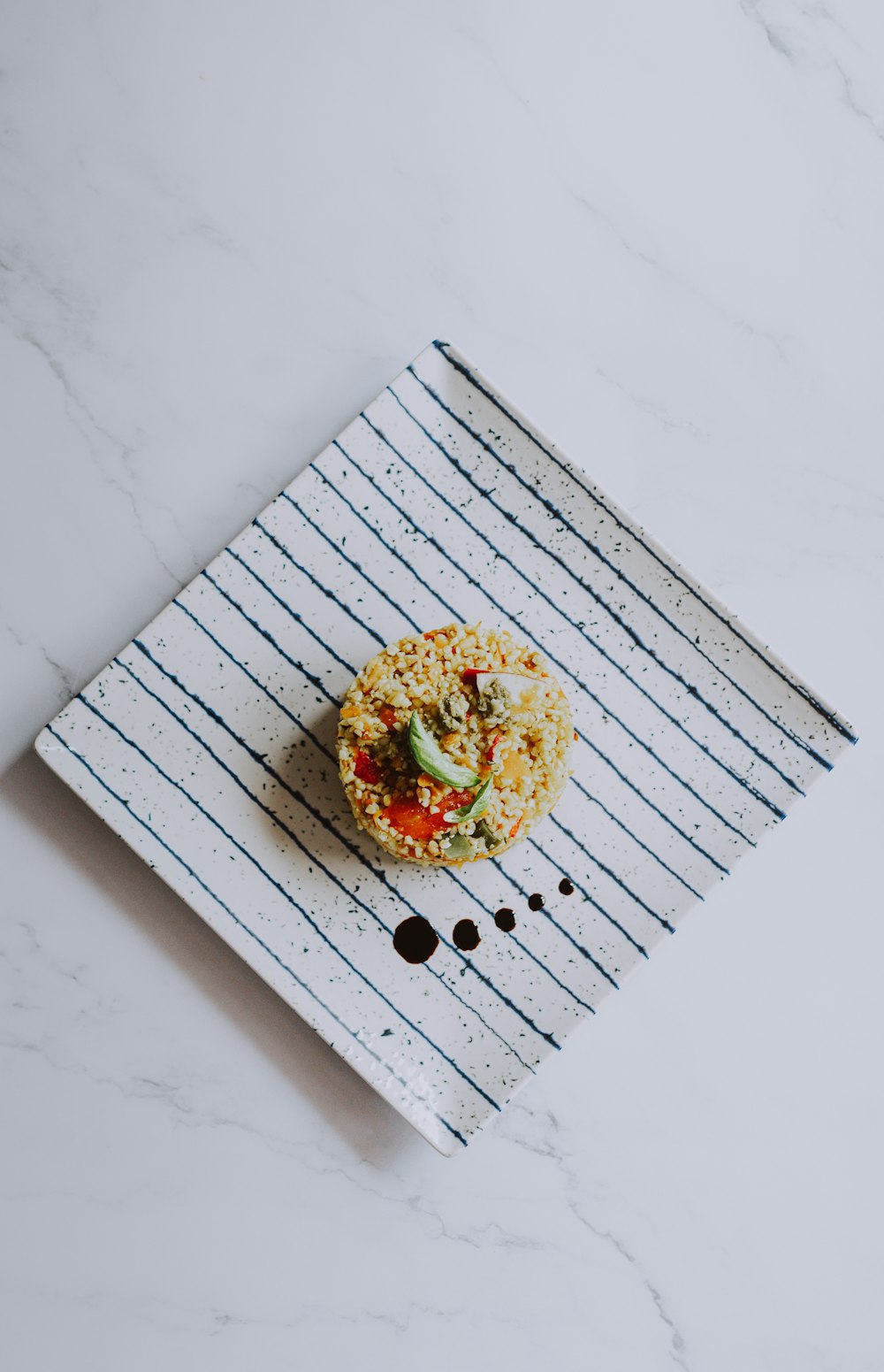 a white plate topped with a pizza covered in toppings