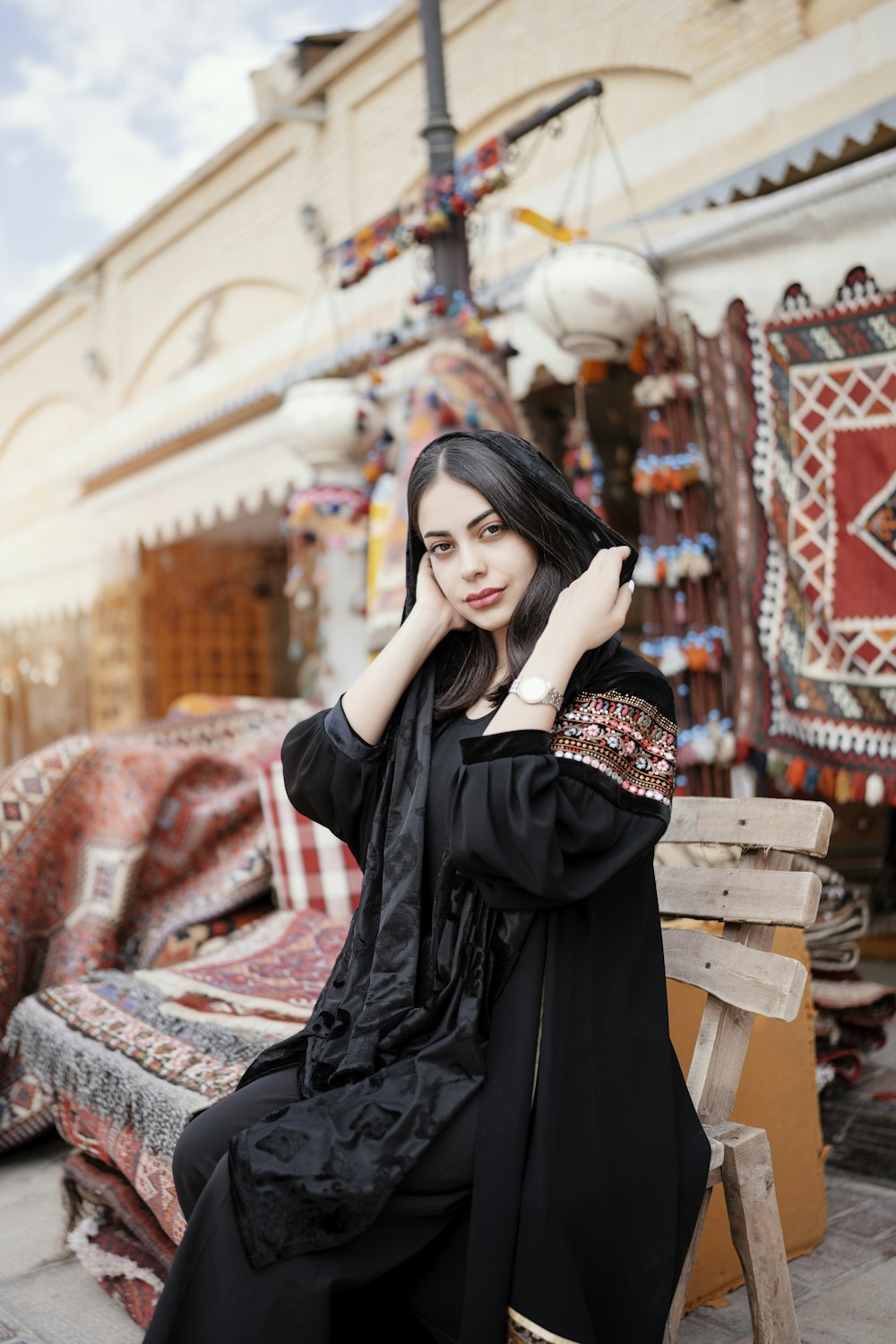 a woman sitting on a bench in front of a store