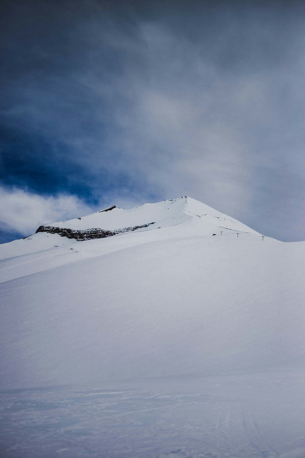 a man riding skis down a snow covered slope