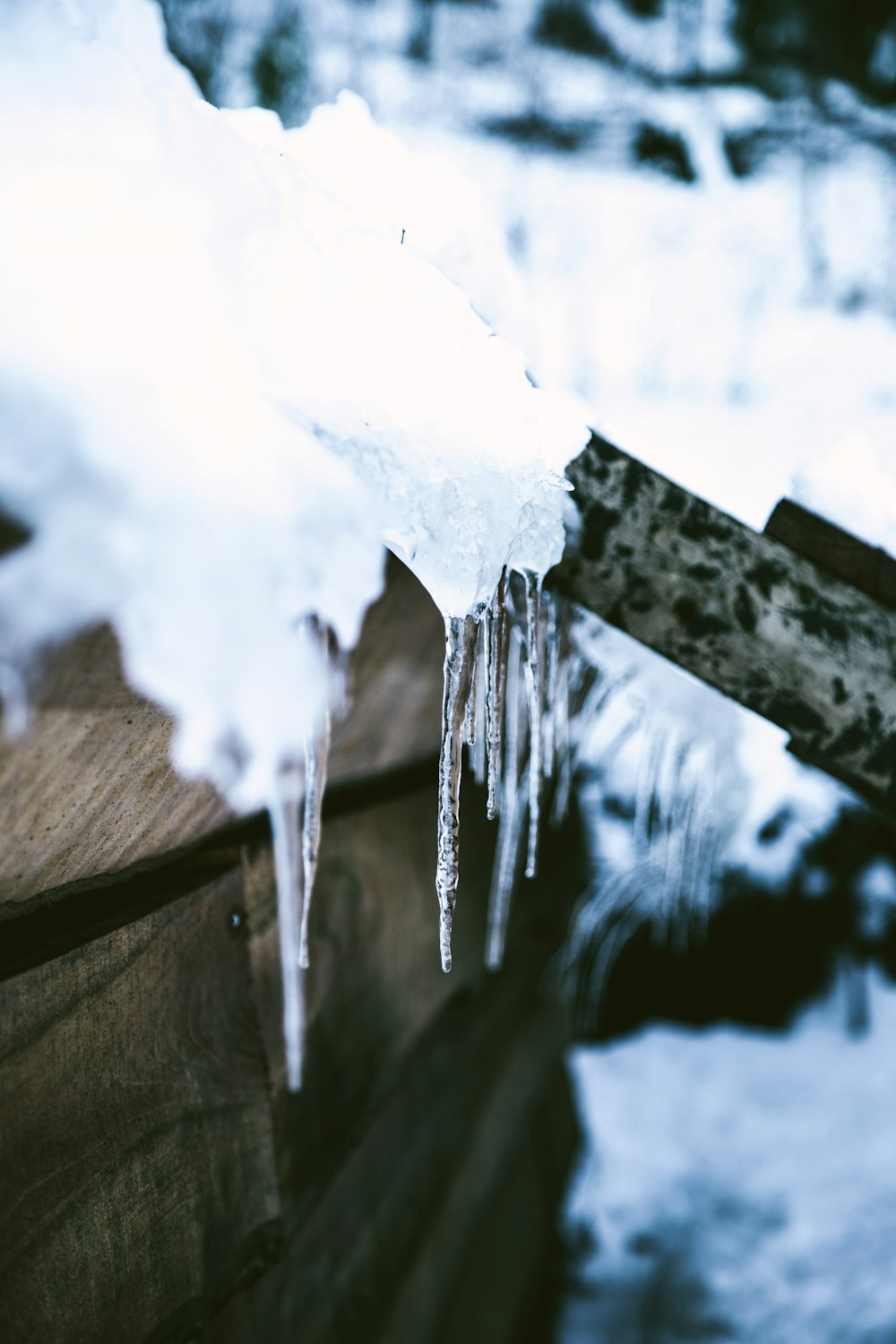 a piece of wood with icicles hanging off of it