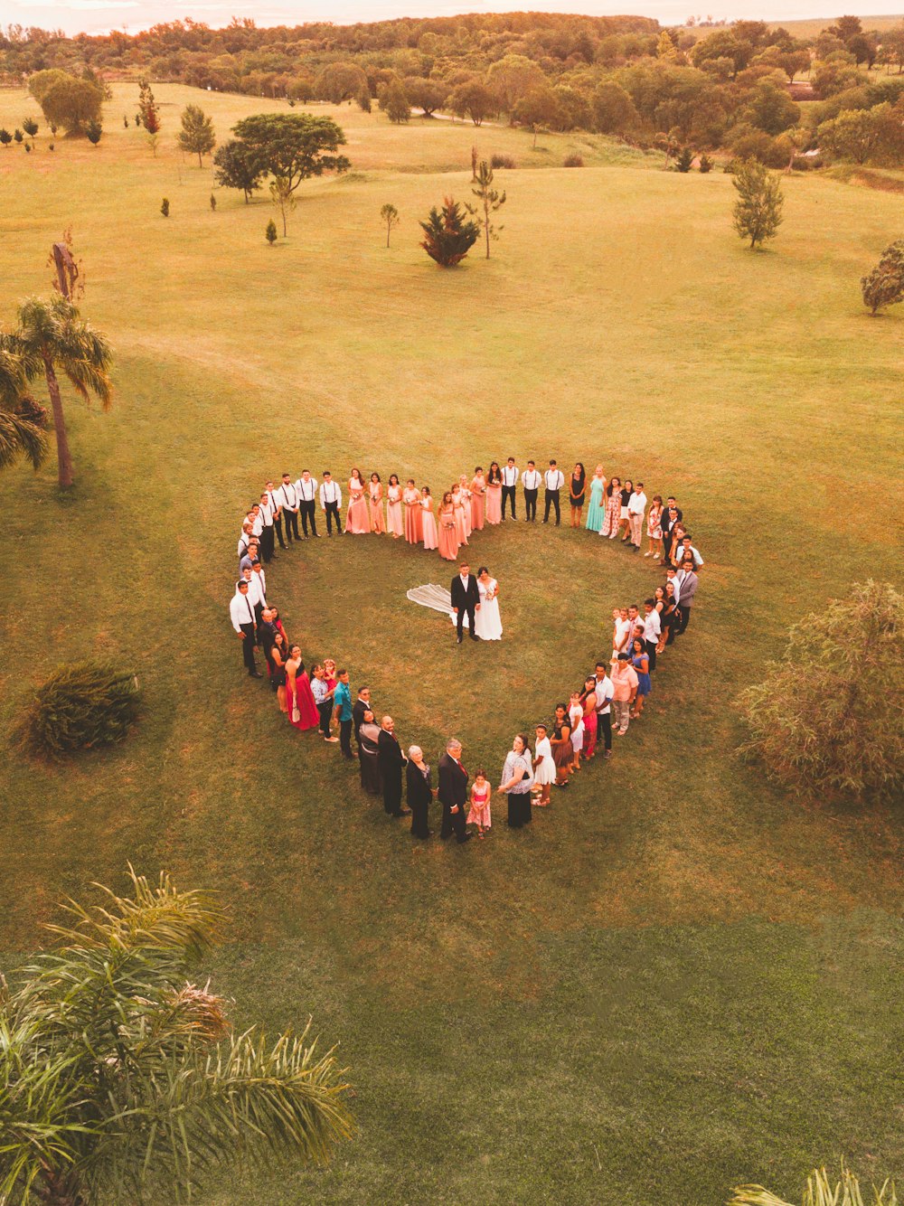 a group of people standing in the shape of a heart