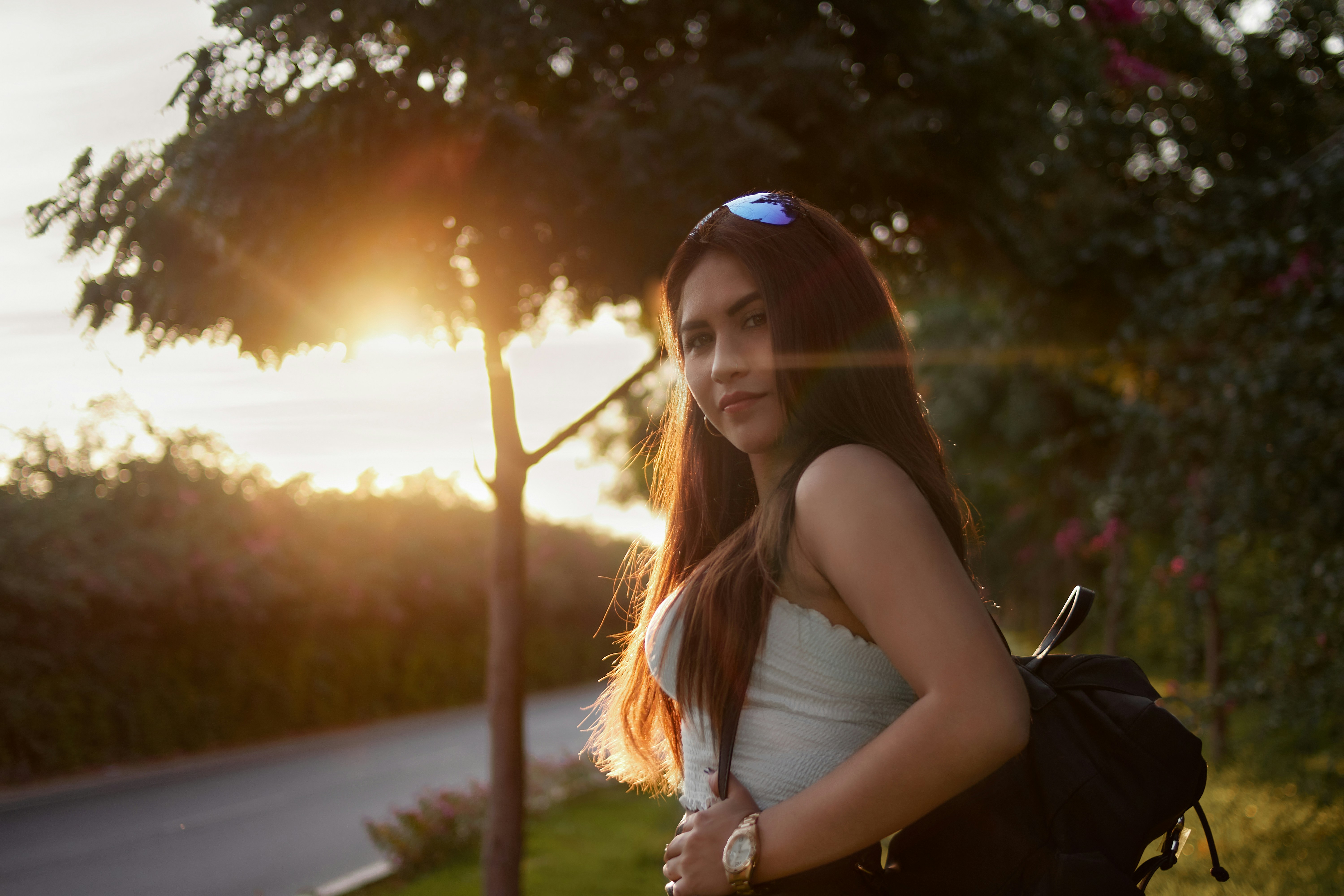 a woman with a black backpack and a white shirt