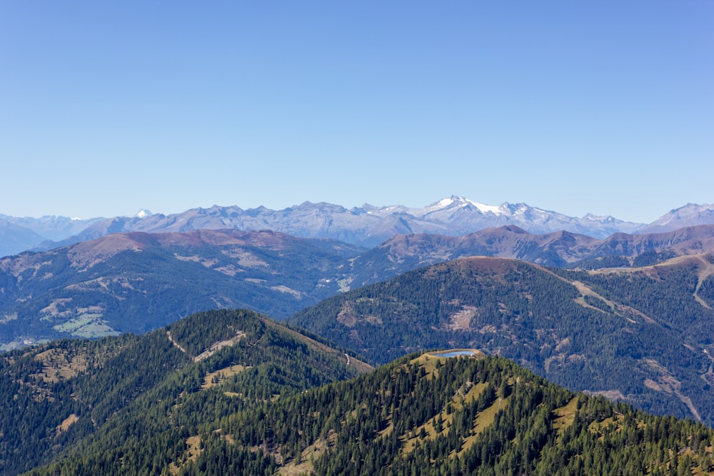 a view of a mountain range with a lake in the foreground