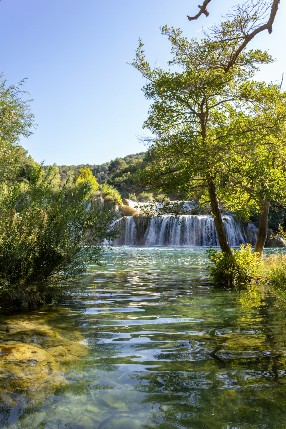 a river with a waterfall in the background