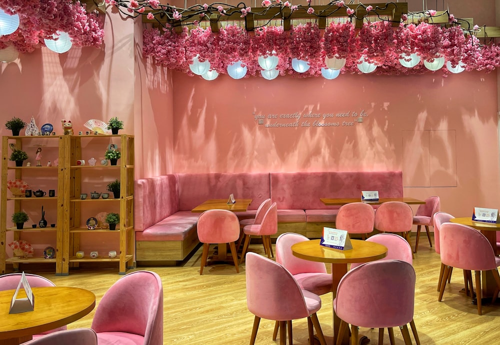 a restaurant with pink chairs and pink walls