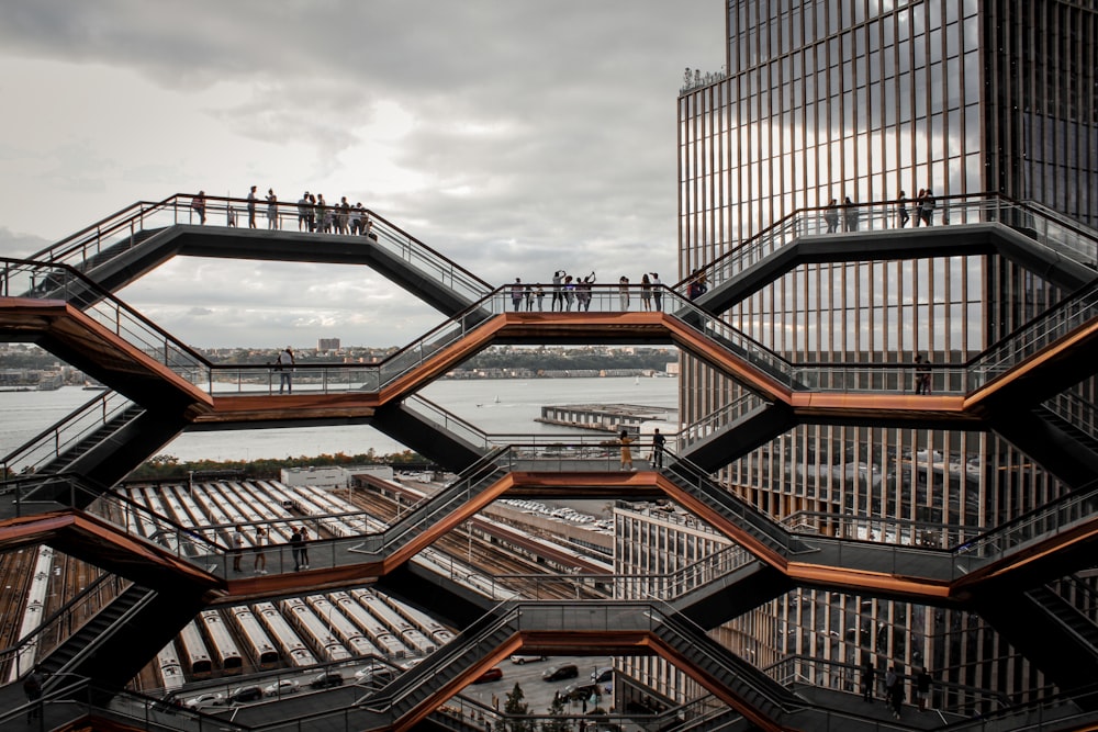 a group of people standing on top of a metal structure