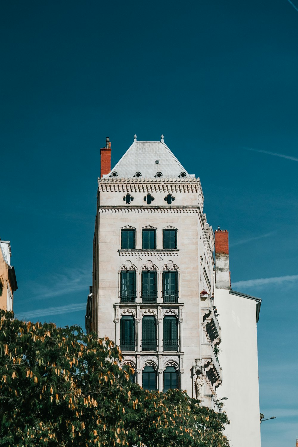 a tall white building sitting next to a tall white building