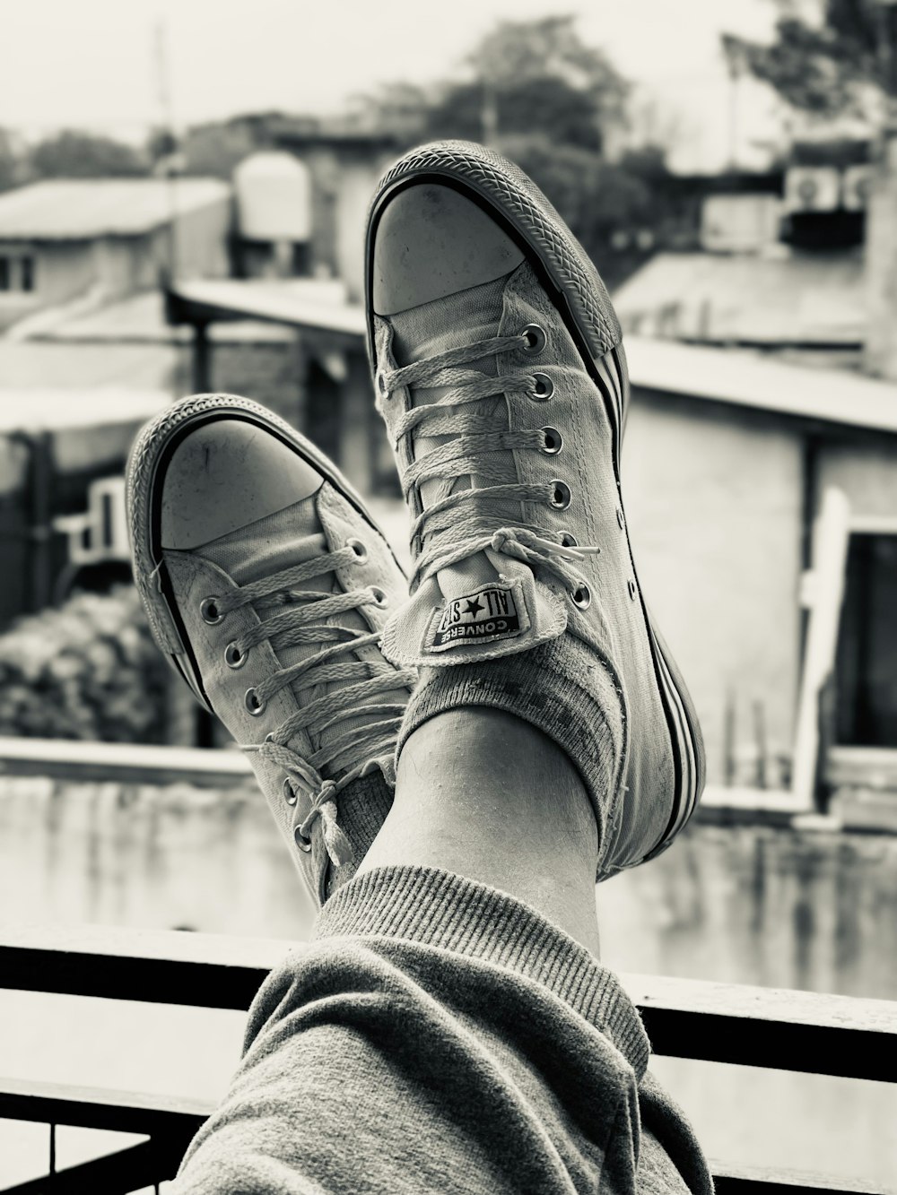 a person's feet with tennis shoes on