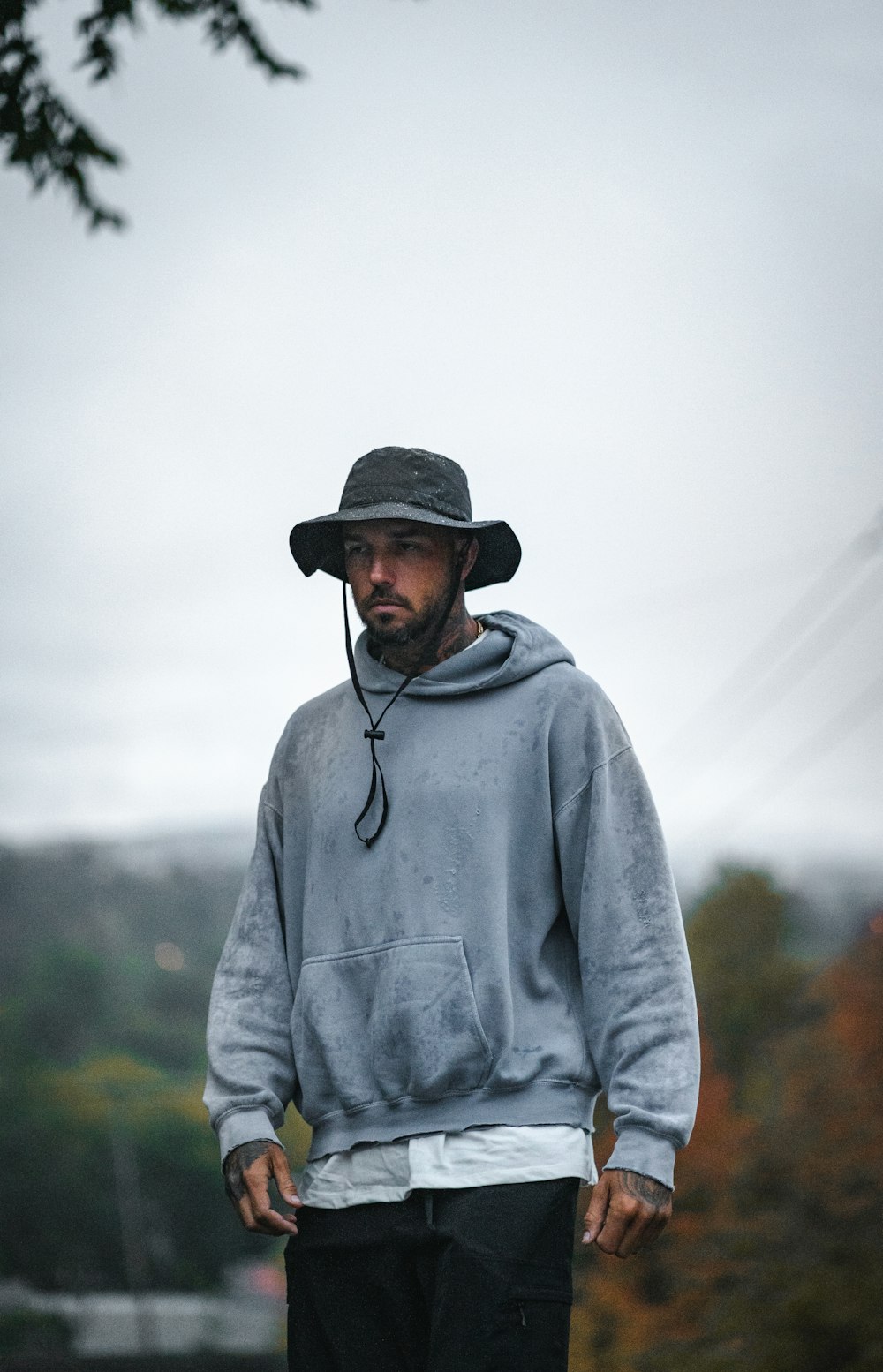 a man wearing a hat and a sweatshirt