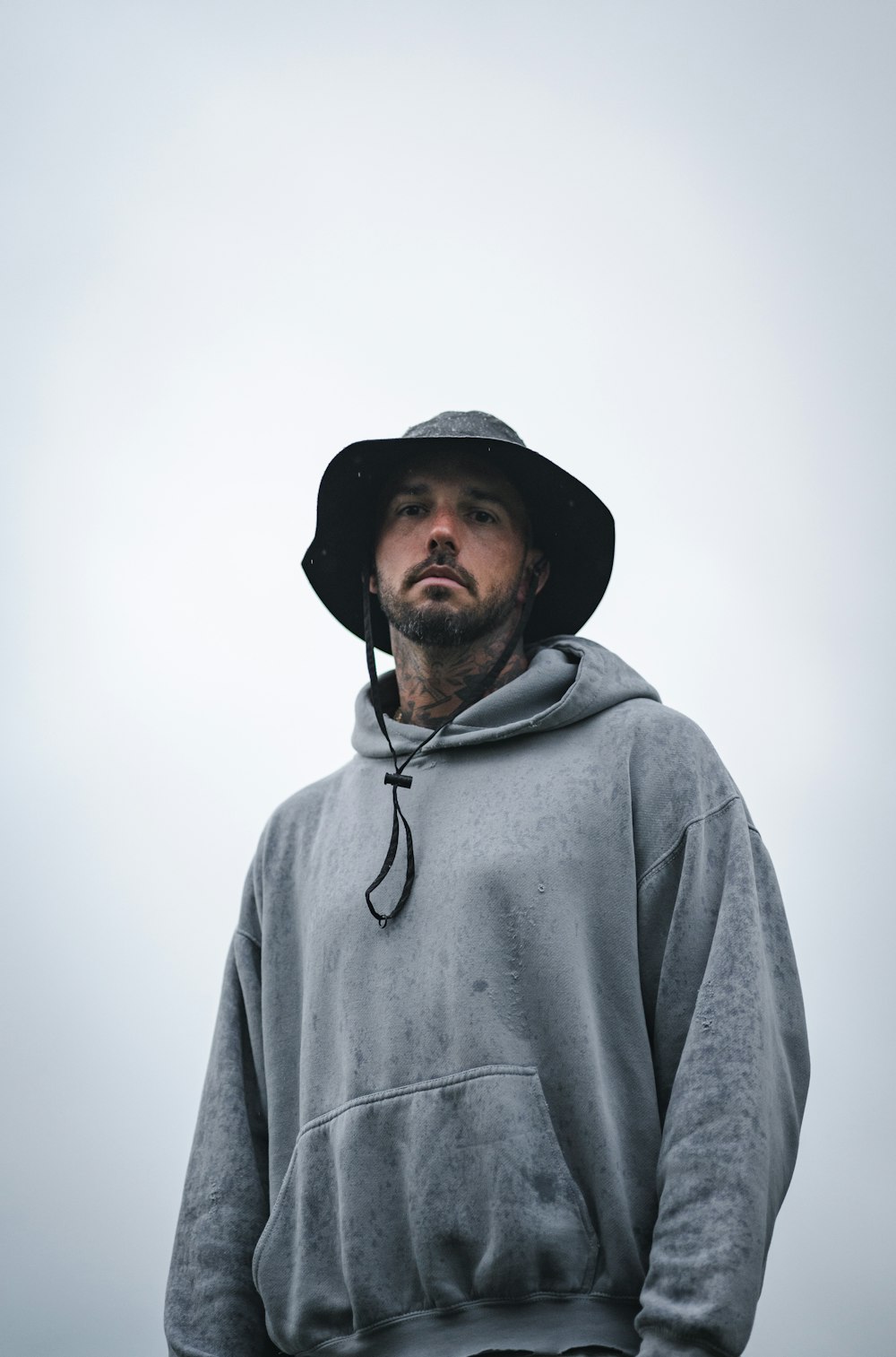 a man wearing a hoodie and a hat