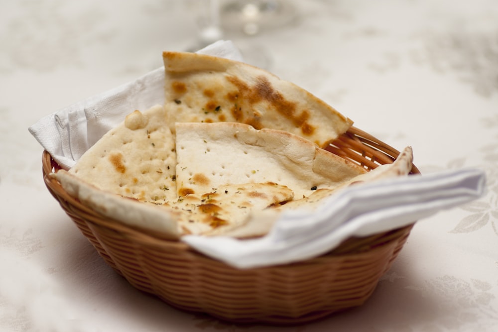 a basket of pita bread with a fork in it