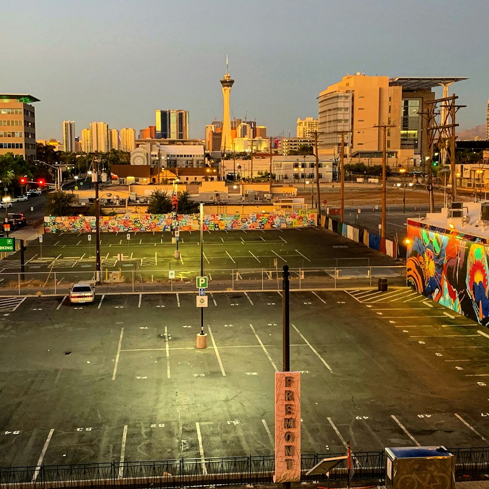 an empty parking lot in front of a city skyline