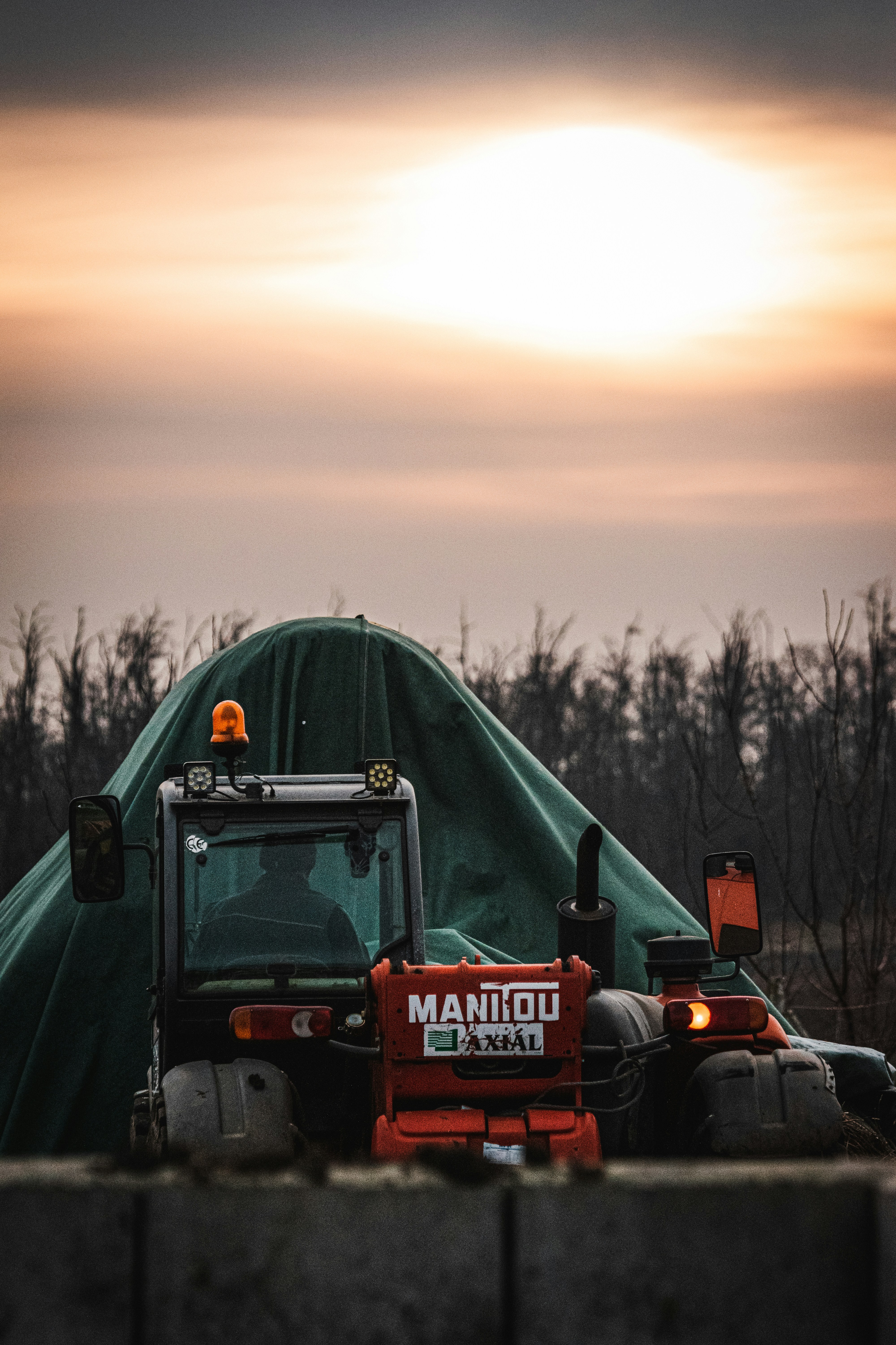 a tractor is parked in front of a tent