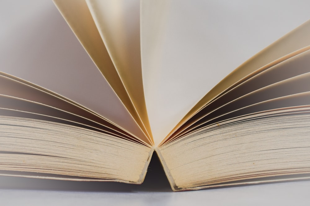 a close up of an open book on a table