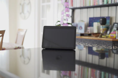 Close-up of a digital beauty ebook displayed on a glass-like tablet with elegant shadows.