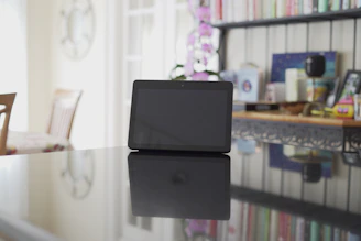Close-up of a digital beauty ebook displayed on a glass-like tablet with elegant shadows.