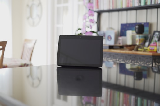 A digital tablet displaying colorful educational content with textbooks nearby