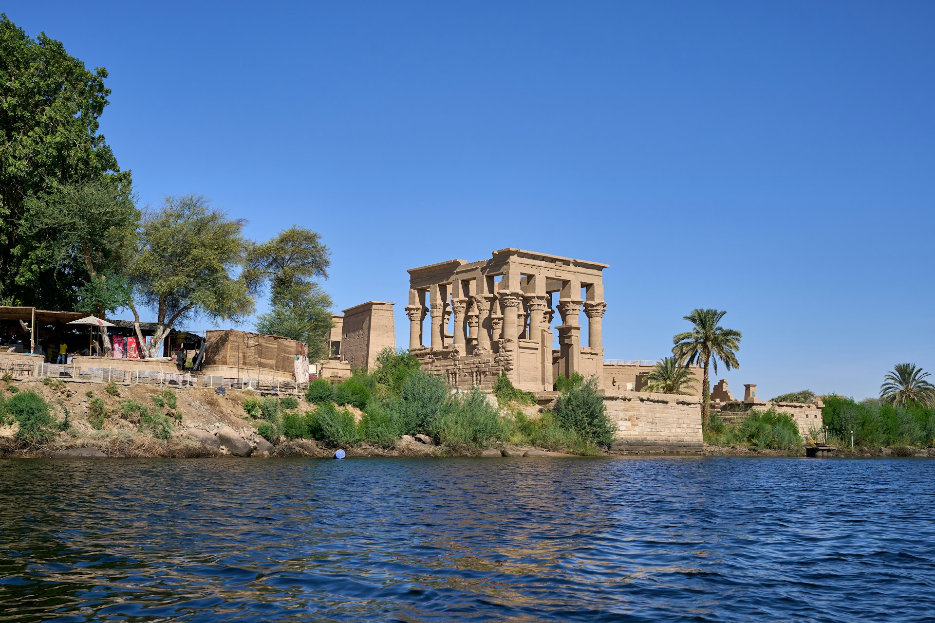 a large building sitting on top of a cliff next to a body of water