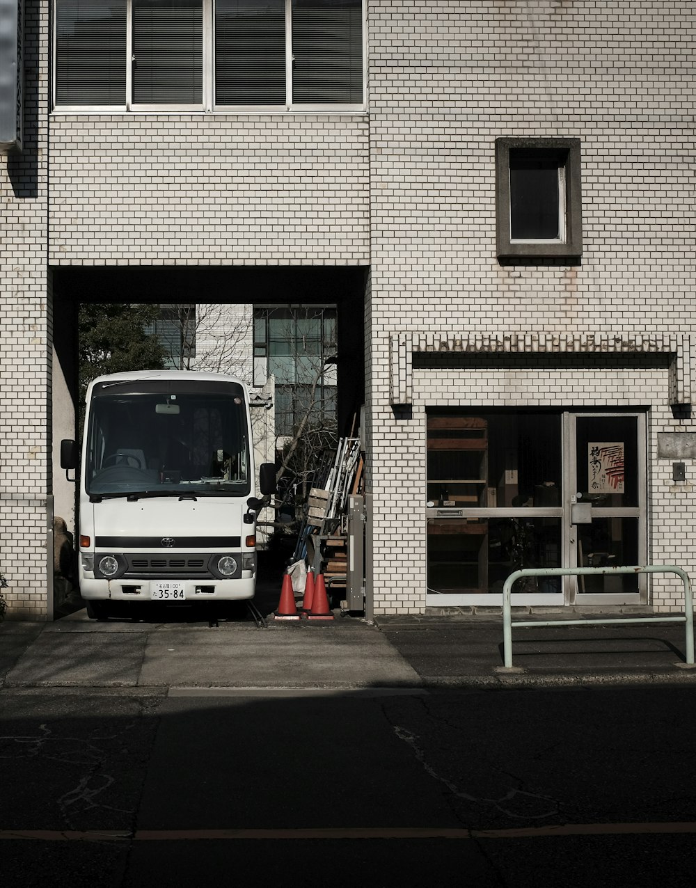 a white bus parked in front of a building