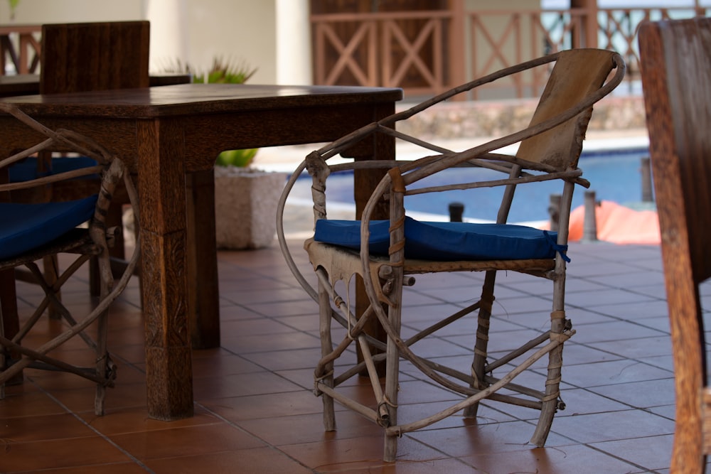 a wooden table and chairs with blue cushions