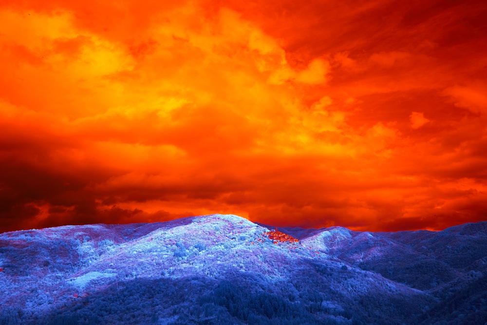a red and blue sky over a mountain range