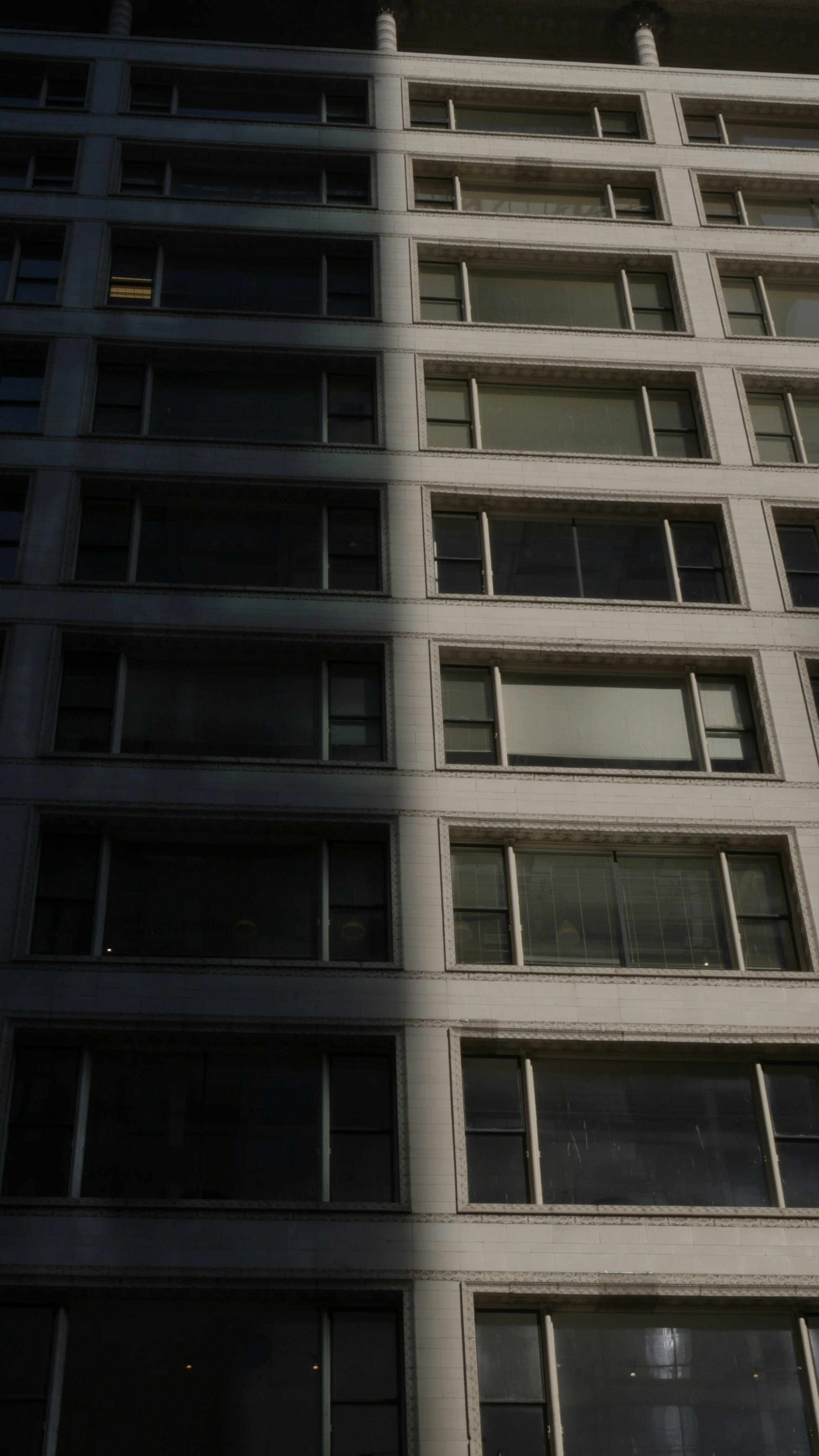 a clock on the side of a tall building