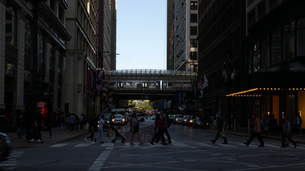 a group of people crossing a street in a city