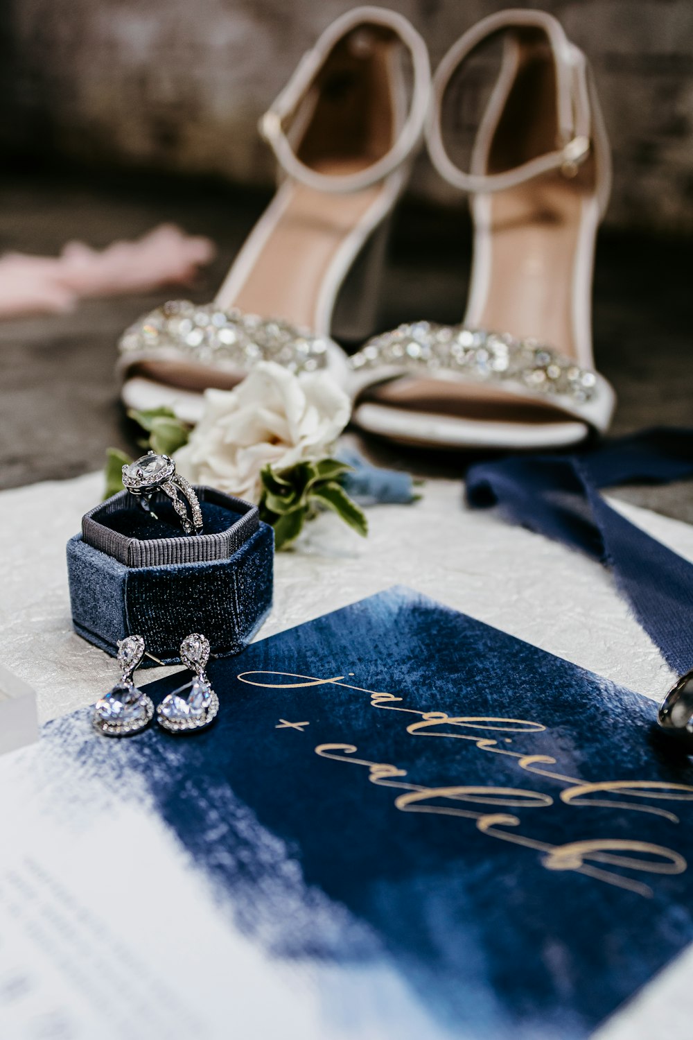 a pair of shoes and a ring on a table