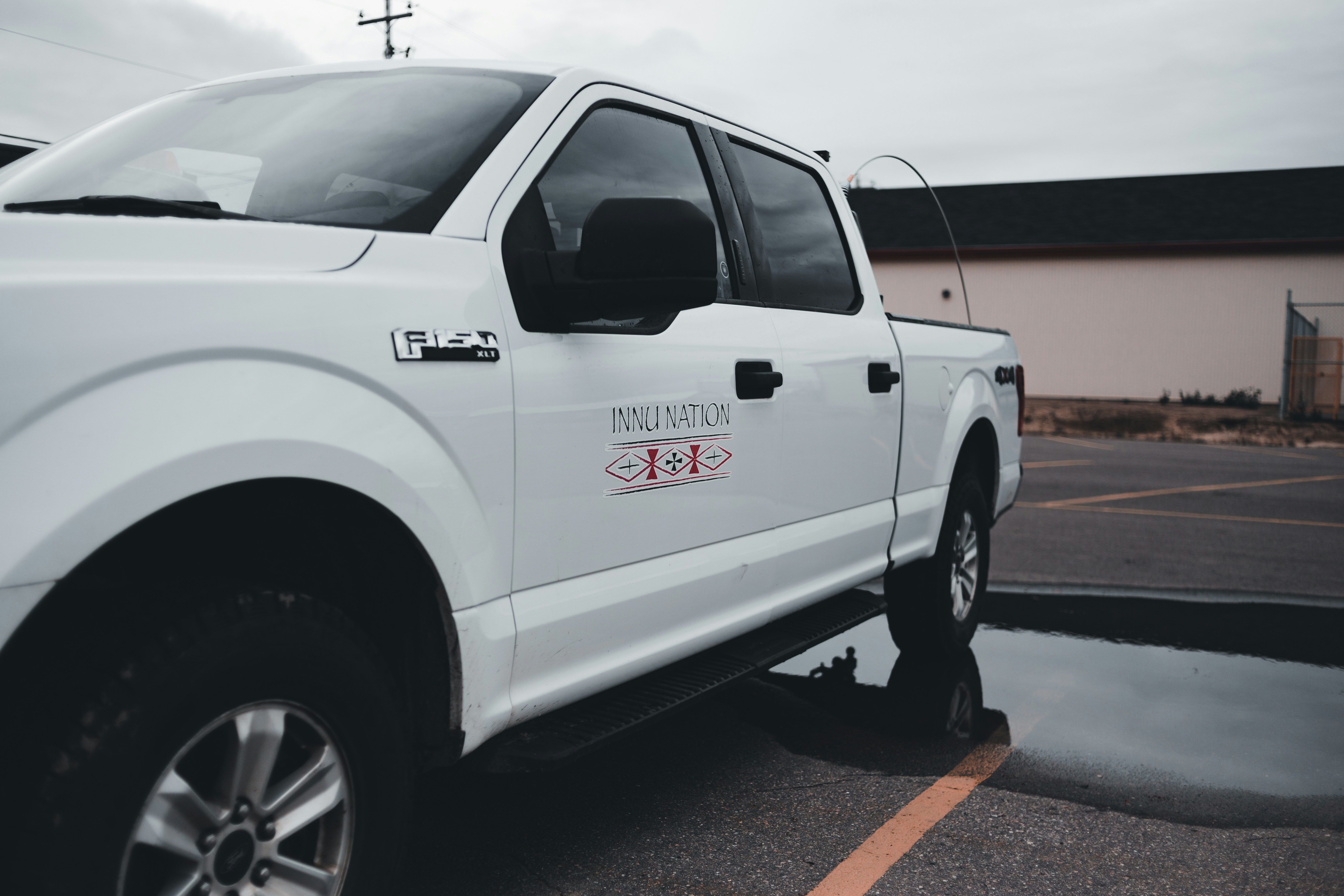 A clean, modern service vehicle parked outside a residential home - Which local dealers and installers specialize in