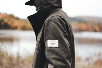 a person wearing a black jacket and a hat