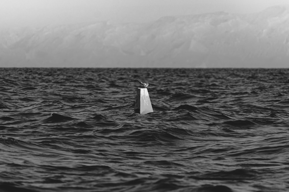 a small boat in the middle of a large body of water