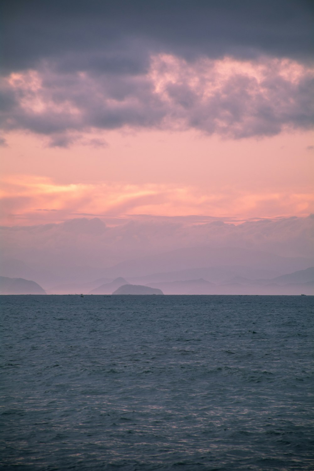 a large body of water under a cloudy sky