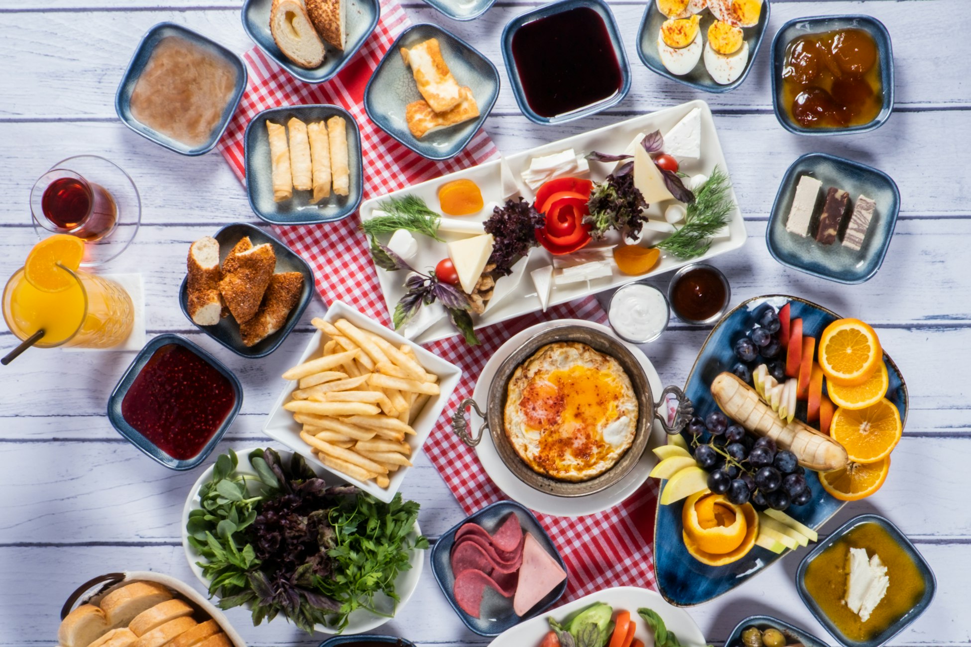A Turkish breakfast spread of small plates, eggs, fruit and bread