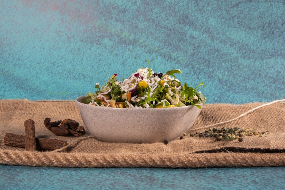 a white bowl filled with a salad on top of a table