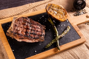 a steak and asparagus on a cutting board