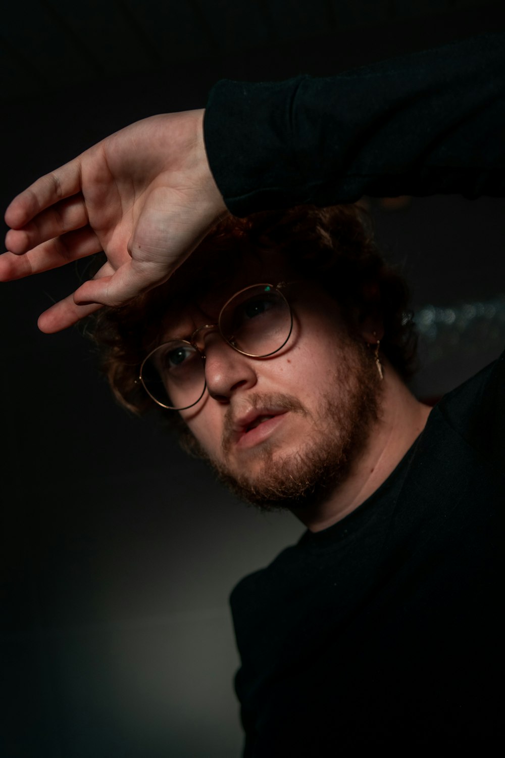 a man with glasses and a black shirt