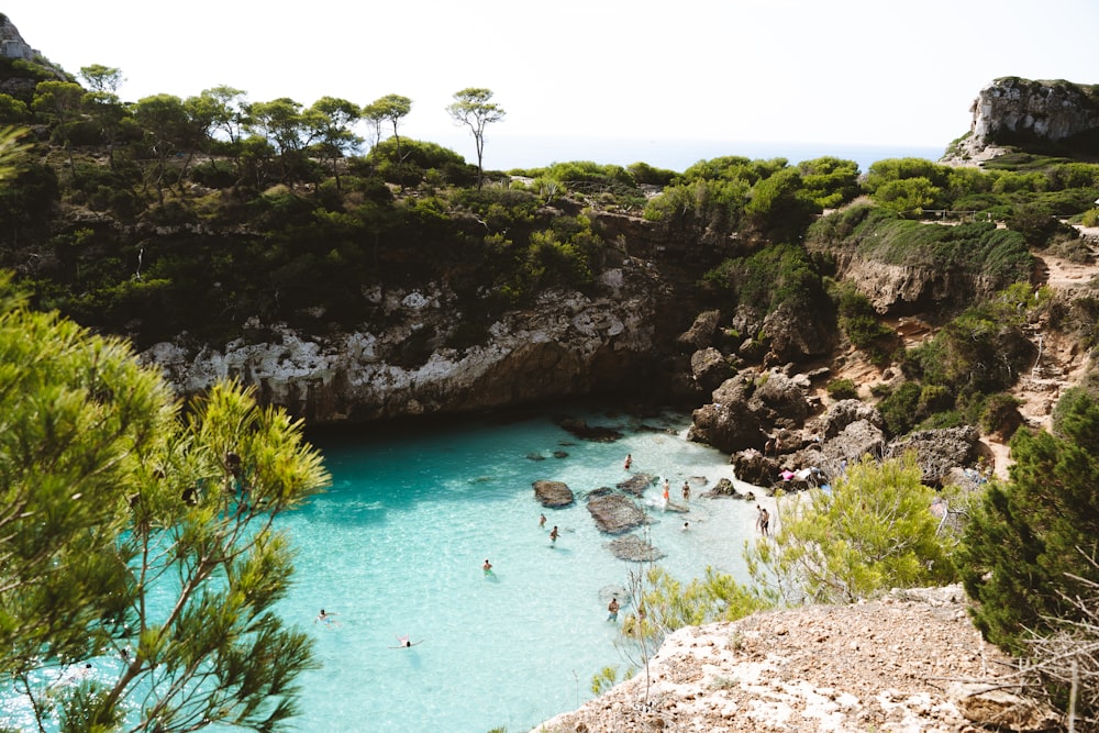 a group of people swimming in a blue lagoon