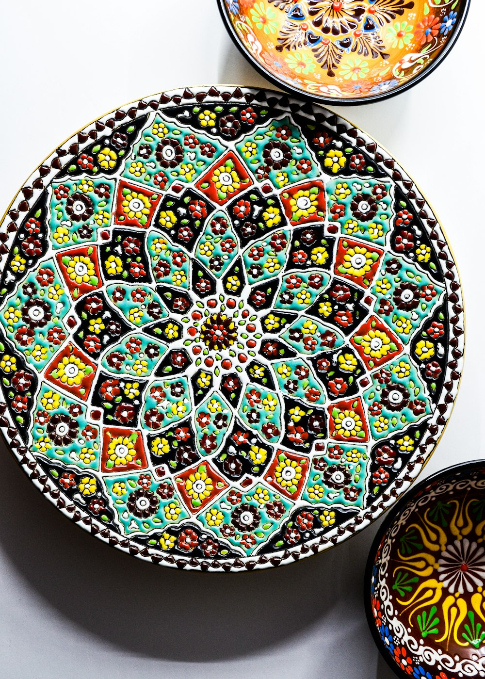 a colorful plate and bowl on a table