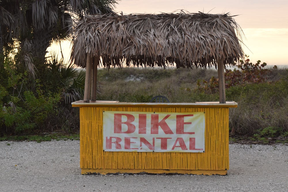 a tiki stand with a sign that says bike rental