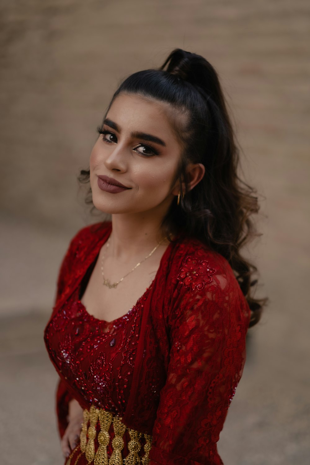 a woman in a red dress posing for a picture