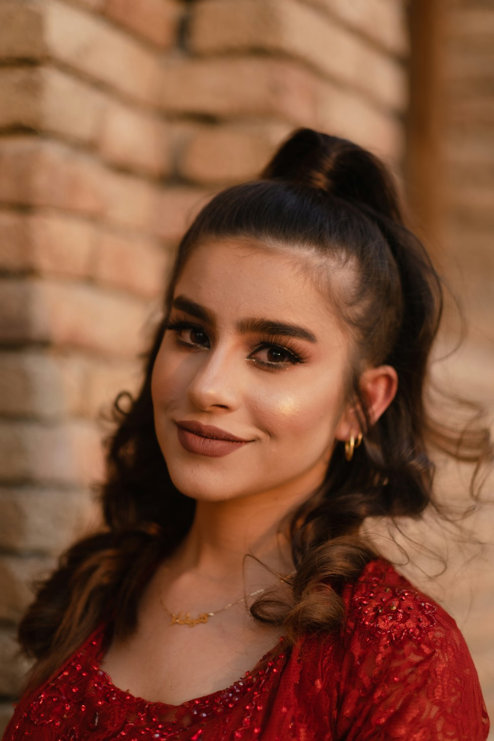 a woman in a red dress is smiling