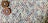 A close-up view of a knitted fabric featuring a textured pattern with a mix of colors including purple, blue, and beige. Two decorative circular buttons with intricate, colorful patterns are attached, providing a contrast against the muted tones of the fabric.