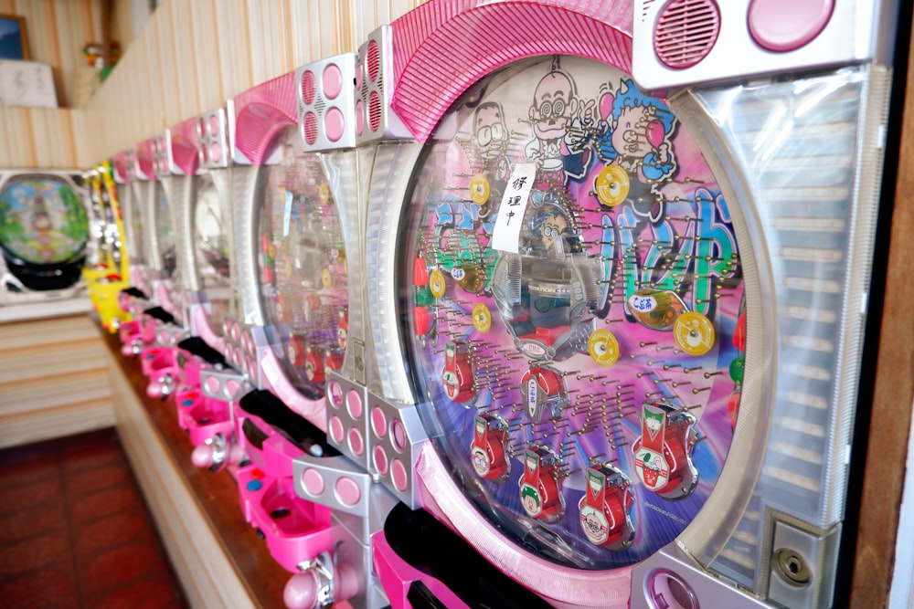 a row of coin machines sitting next to each other