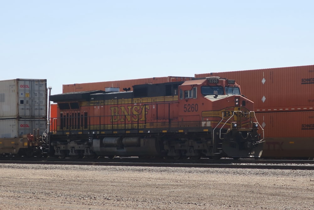 a train traveling down train tracks next to a field