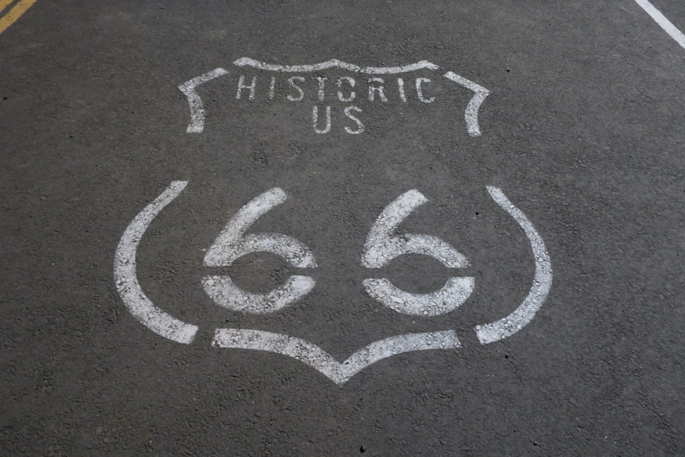 a route 66 sign painted on the asphalt of a street