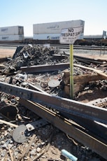 a train track with a no trespass sign in the middle of it